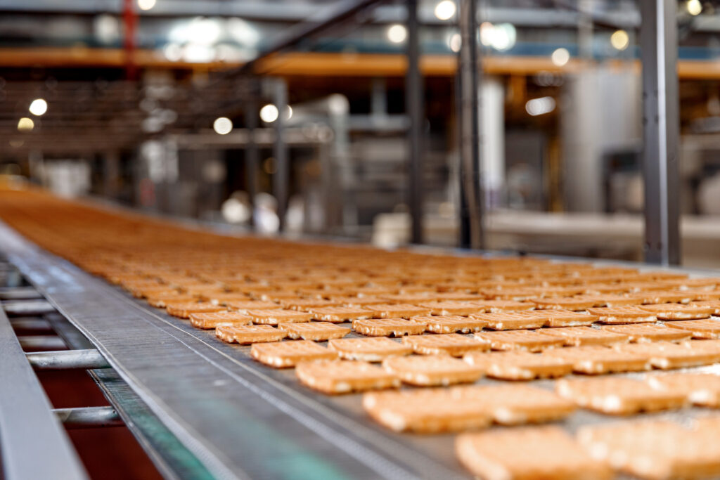 industrial baking conveyor with baked goods on it